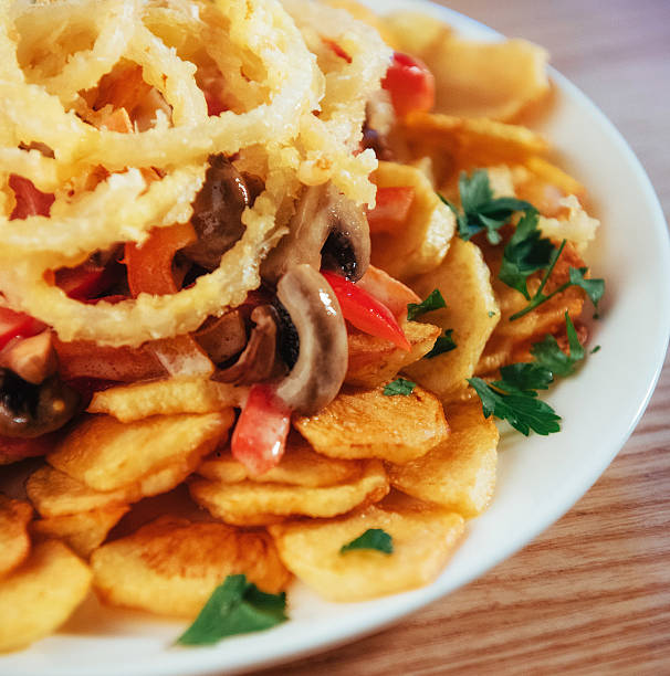 istock salad with fried potatoes, mushrooms and tomatoes 582318552