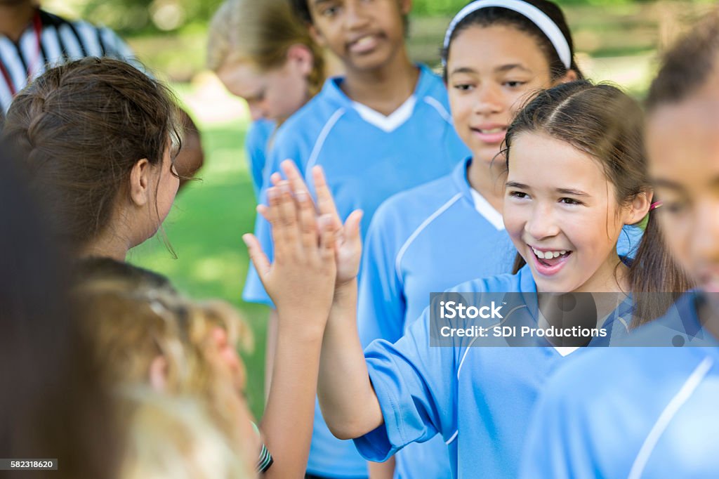 Glückliches Mädchen gibt anderen Team hohe Fünfen nach gutem Spiel - Lizenzfrei Kind Stock-Foto