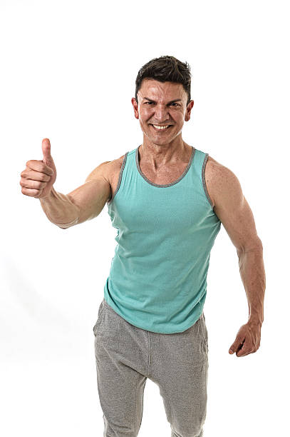istock bodybuilder man smiling happy corporate pose giving thumb up 582319288