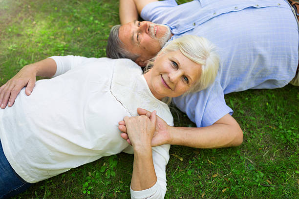 istock Senior couple lying on grass 582319496