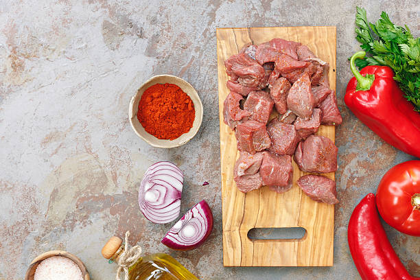istock Raw diced meat with vegetable and spices, cooking preparation 582319896