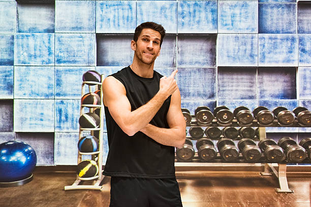 istock Muscular man standing in gym 582320284