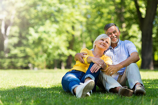 istock Senior Couple Sitting In Park 583689334