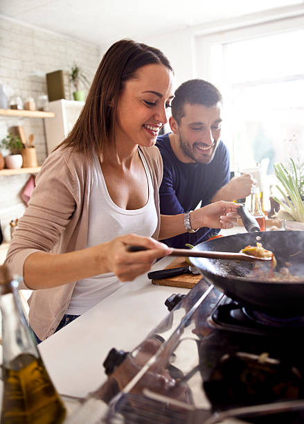 istock Man and woman preparing lunch 583690794