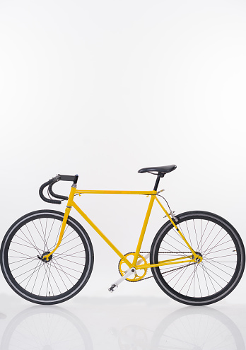 Yellow bike on white background no people.