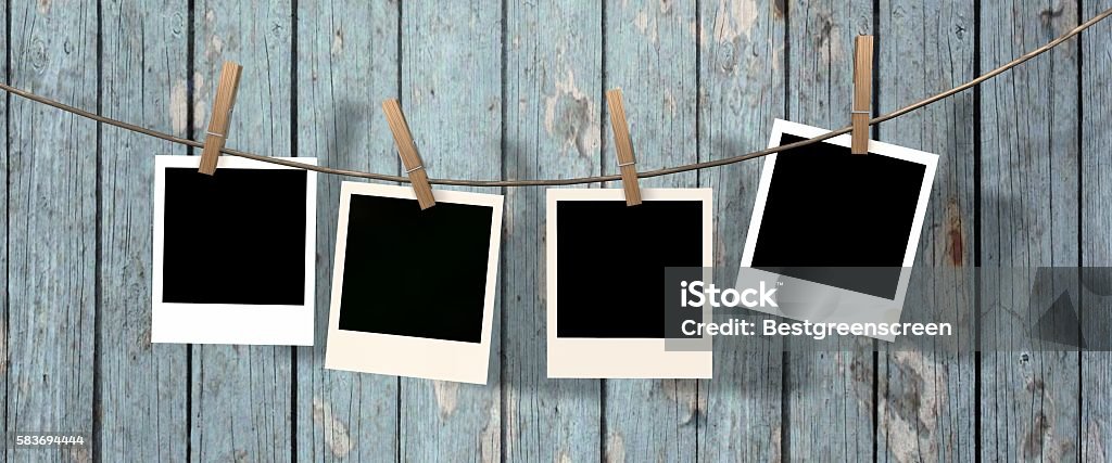 four blank instant photos hanging on the clothesline Hanging Stock Photo