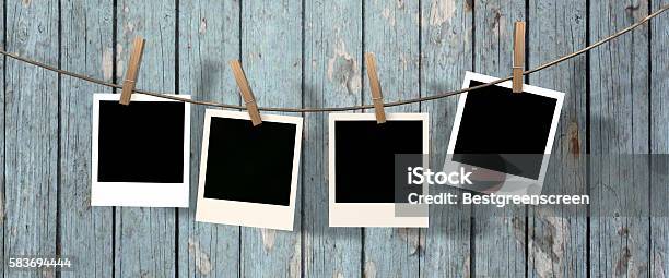 Four Blank Instant Photos Hanging On The Clothesline Stock Photo - Download Image Now