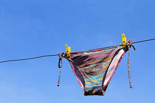 istock Drying woman swimsuit against the blue sky 583696406
