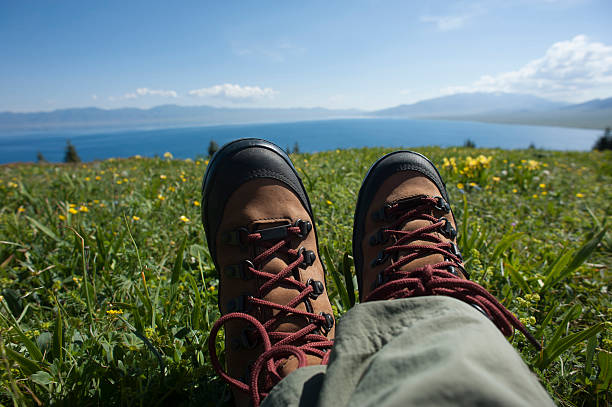 istock hiker sitting on a grass mountain top 583696592