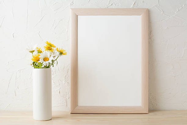 istock Frame mockup with white and yellow chamomiles in vase 583696676