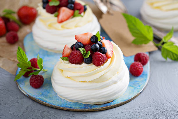 istock Pavlova cakes with cream and fresh berries 583698112