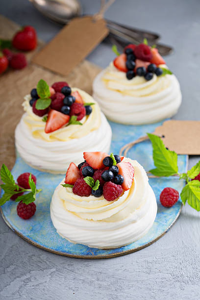 istock Pavlova cakes with cream and fresh berries 583698162