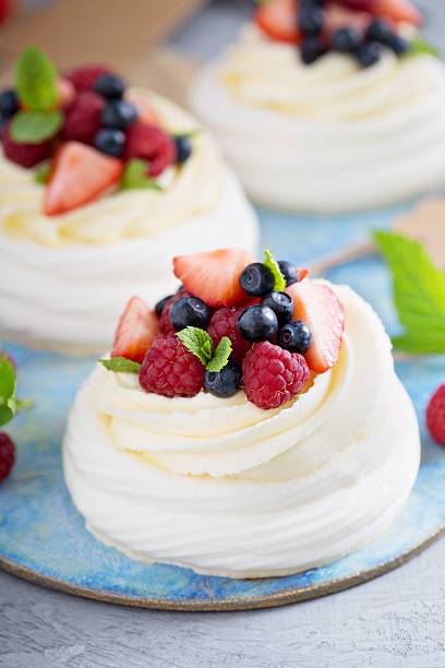 istock Pavlova cakes with cream and fresh berries 583698220
