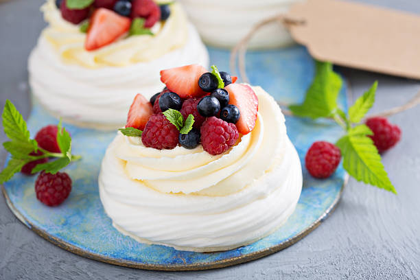 istock Pavlova cakes with cream and fresh berries 583698260