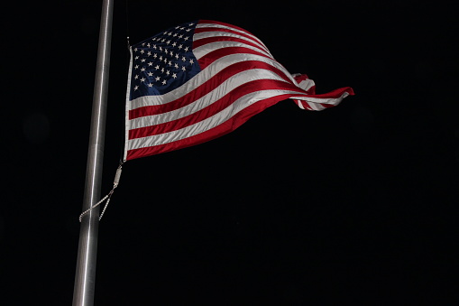 US Flag shot at night with flash while it was at half-mast.