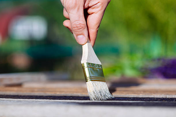 istock Paint brush on wooden table use for home decorated. 583701054