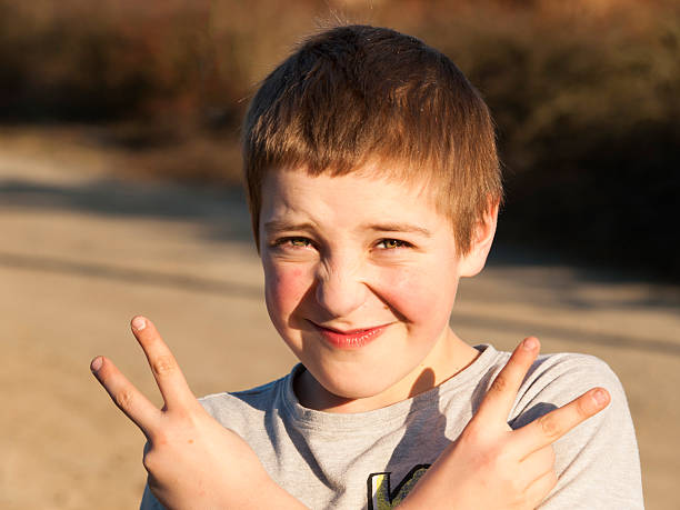 istock Young boy make gesture of victory 583702500