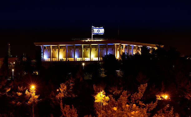 Knesset with flag Parliament of Israel at night Knesset the Parliament of Israel with flying waving flag of Israel at night israeli ethnicity stock pictures, royalty-free photos & images