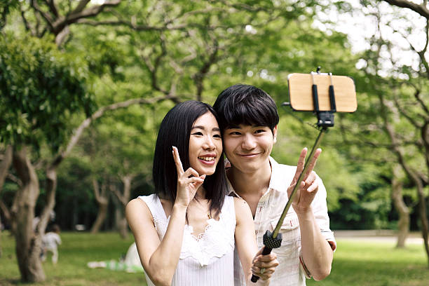 istock Japanese couple taking selfie 583704586