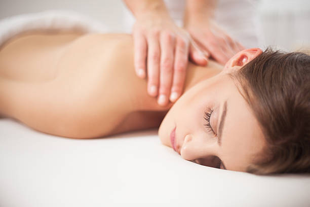 istock Young woman receiving back massage at spa 583705190