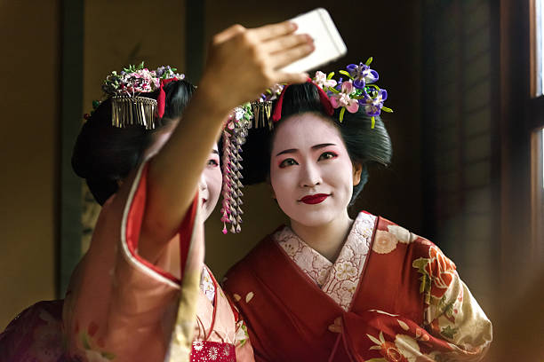 Maiko Girls taking selfie Maiko Girls taking selfie modern geisha stock pictures, royalty-free photos & images