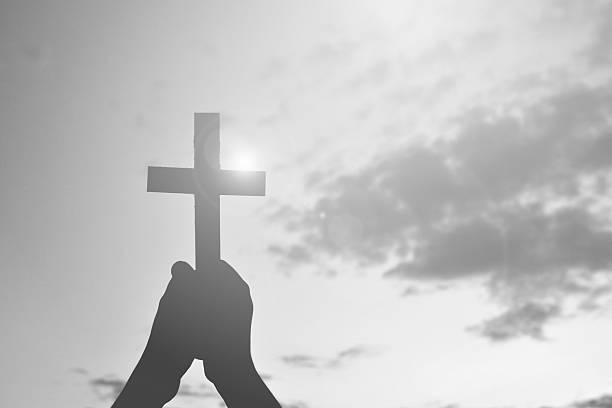 istock Silhouette people jesus and cross at sunset 583707782