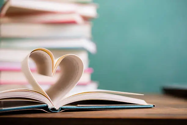 Photo of Heart shape in open school book pages.