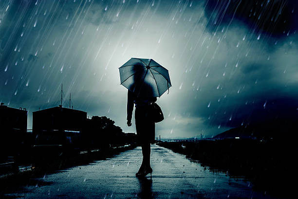 istock Woman are holding an umbrella, dark image 583708322