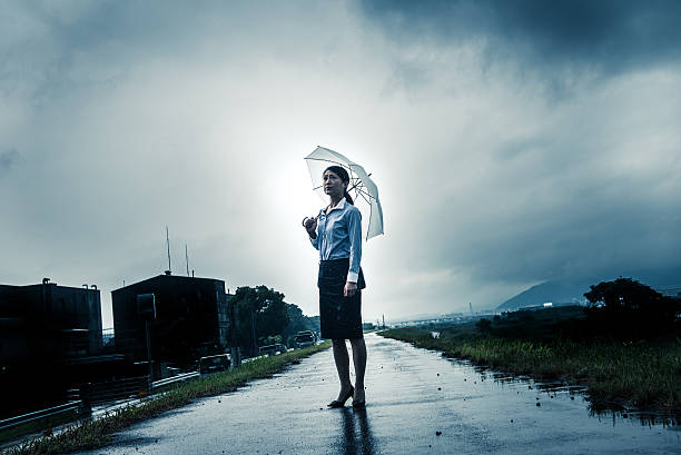 istock Woman are holding an umbrella, dark image 583708360