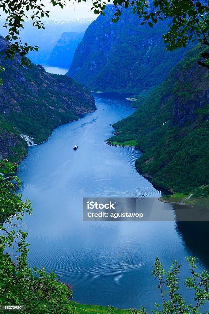 Naeroyfjord idyllic fjord landscape, ship Cruise, dramatic evening, Norway, scandinavia You can see my collection of photos of stunning Norway: mountains and fjords (Oslo, Geiranger, Geiranger Fjord, Alesund, Bergen, a Lot of Fjords, Jotunheimen, Jostedal, Glaciers, Trollstigen, Aurland, sunrises, sunsets, and much others!!) in the following link below:  Fjord Stock Photo