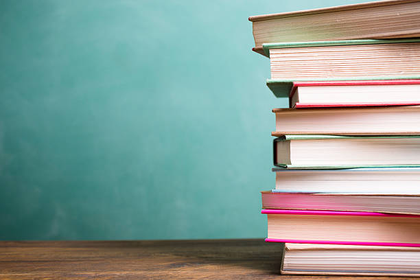 school books stacked on desk with chalkboard. - blackboard back to school green picture frame imagens e fotografias de stock