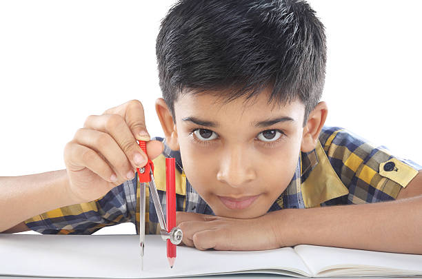 Indian boy with drawing compass stock photo