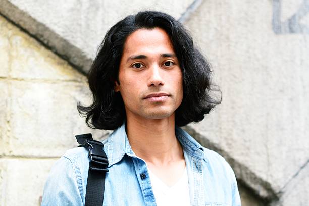 Man looking at camera A man in his late 30s looking at the camera. nepali people stock pictures, royalty-free photos & images