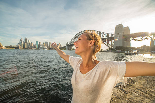 istock Young woman relaxing in Sydney harbour at sunset 583710810