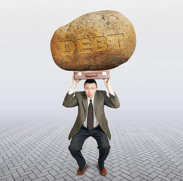 istock Debtor under the burden of debt 583711692