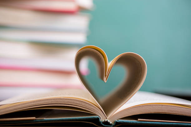 istock Heart shape in open school book pages. 583714236