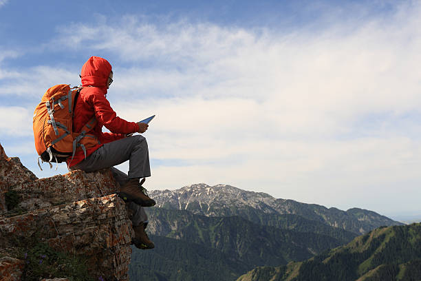 istock woman backpacker use digital tablet taking photo on mountain peak 583715126