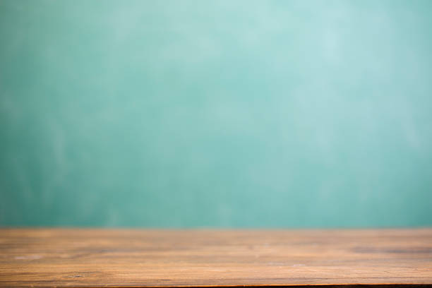 istock Back to school background with desk and green chalkboard. 583715862