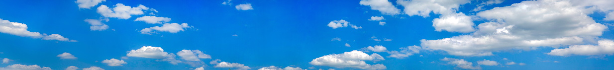 Panoramic view at clouds under blue sky