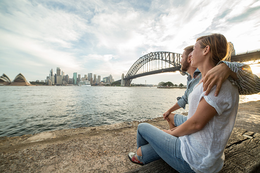 Young couple in Sydney looking out the city skyline.