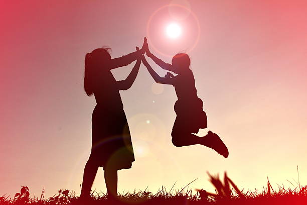 istock silhouettes mother and daughter playing 583718564