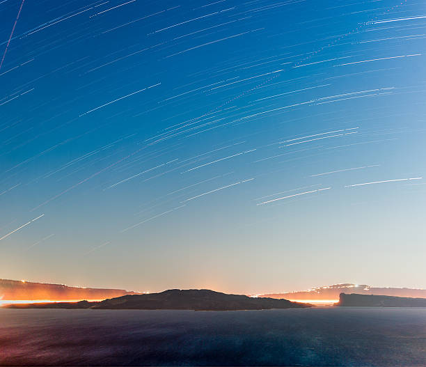 Volcanic crater with star trails stock photo