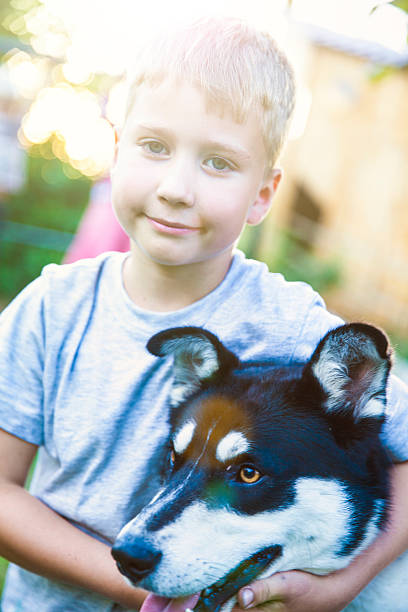 istock Boy with his dog best friend in sunset 583720742