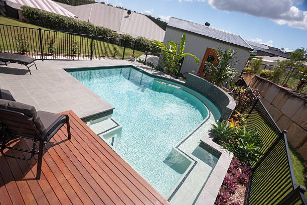 istock Swimming pool angled view with a fence and garden 583721466