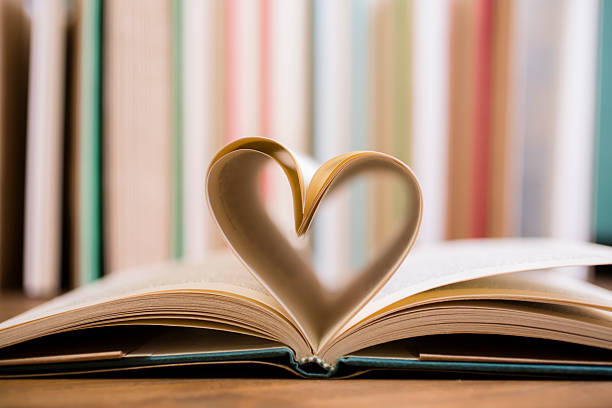 istock Heart shape in open school book pages. 583721642
