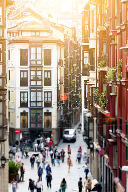 Looking down a street with multi-colored old buildings in Bilbao's Casco Viejo.