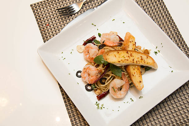 istock spicy spaghetti with shrimp and garlic bread 583724020