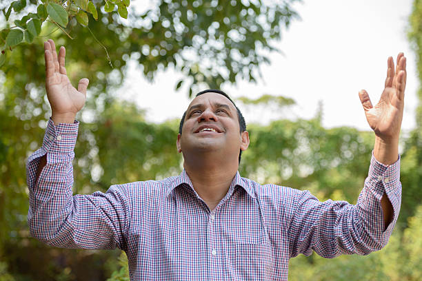 istock Happy Indian man with raised arms outdoors 583724182