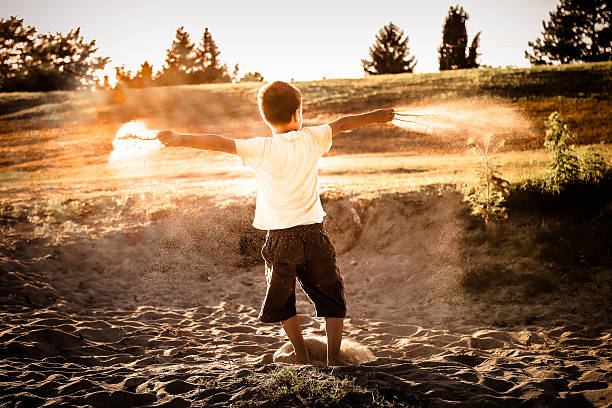 istock Seven years bare foot boy playing with sand 583725342