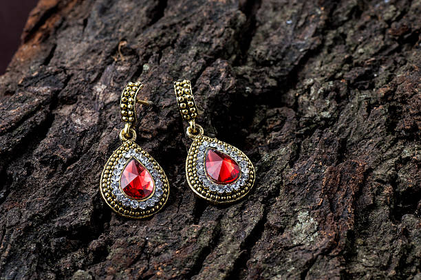 Pair of Earrings on wooden background